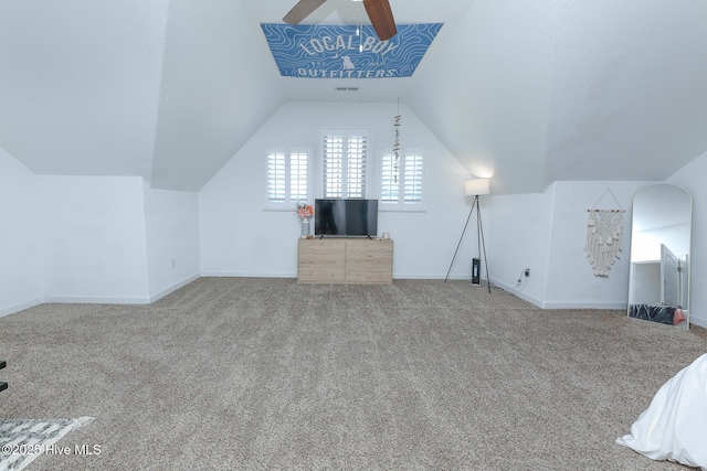 additional living space featuring ceiling fan, vaulted ceiling, carpet flooring, and baseboards
