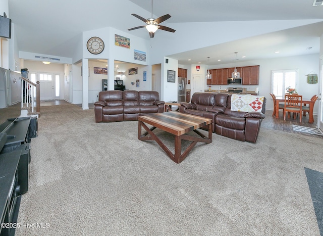 carpeted living area with a ceiling fan, recessed lighting, and high vaulted ceiling