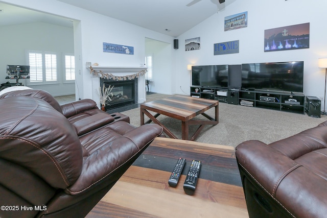 living room featuring carpet floors, vaulted ceiling, a high end fireplace, ceiling fan, and baseboards