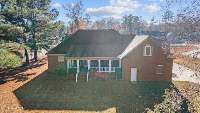117 Quail Woods Dr, New Bern, NC 28560 - back of house featuring brick siding, a lawn, and a porch