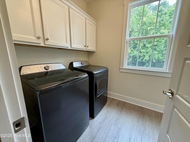 939 Baldwin Park Dr, Wilmington, NC 28411 - washroom featuring cabinet space, washing machine and clothes dryer, wood finished floors, and baseboards