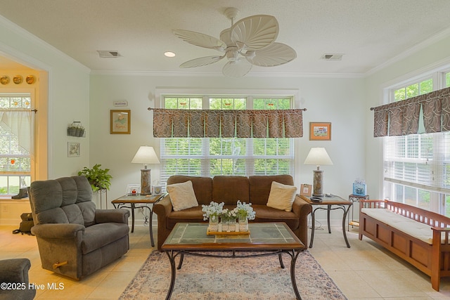 living room featuring ceiling fan, light tile patterned flooring, crown molding, and visible vents