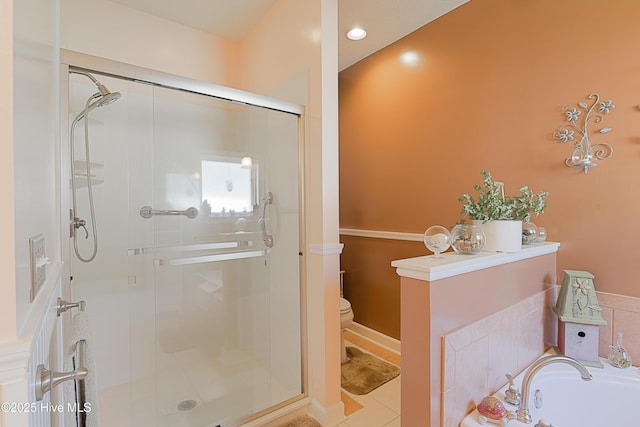 full bathroom with toilet, tile patterned floors, a bath, and a stall shower
