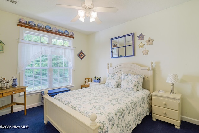 bedroom featuring dark colored carpet, baseboards, and ceiling fan
