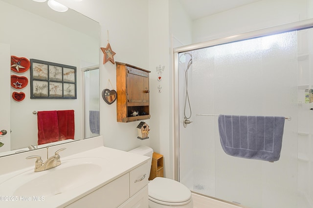 full bathroom with vanity, toilet, and a shower stall