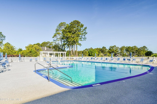pool with fence and a patio area