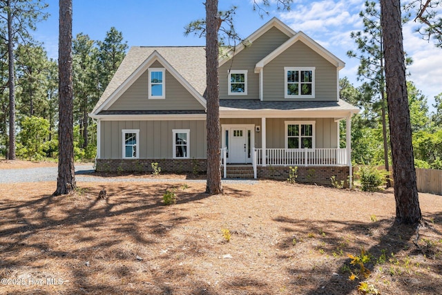 view of front of property featuring a shingled roof, board and batten siding, and a porch