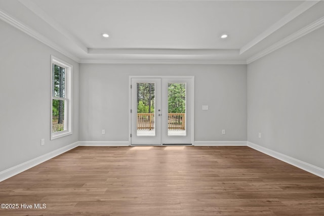 spare room featuring wood finished floors, french doors, baseboards, recessed lighting, and a tray ceiling