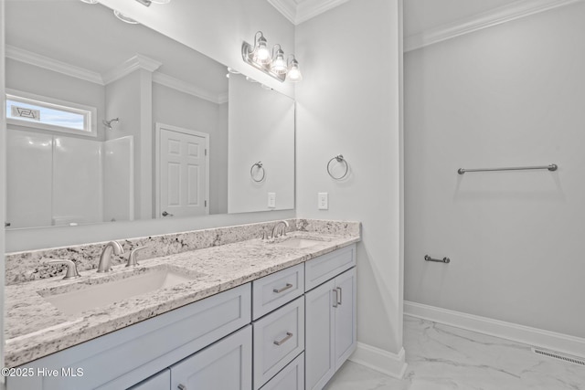 full bathroom featuring marble finish flooring, crown molding, baseboards, double vanity, and a shower