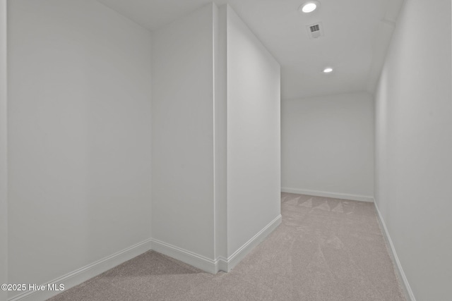 hall featuring light carpet, recessed lighting, and baseboards