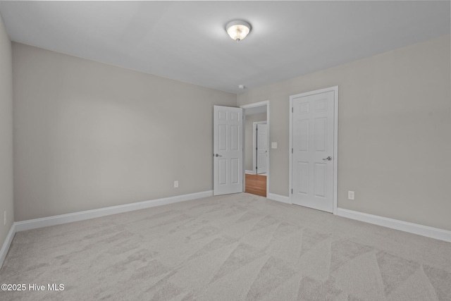 unfurnished bedroom with carpet and baseboards