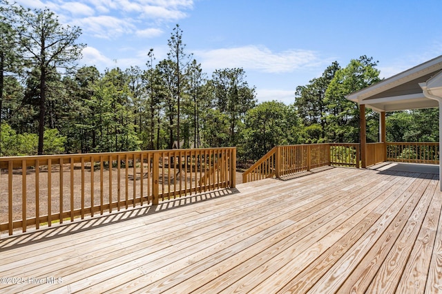 deck featuring view of scattered trees