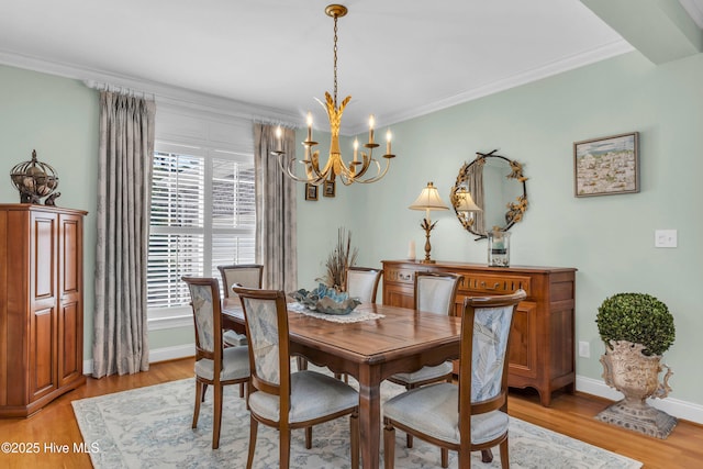 dining room featuring baseboards, light wood finished floors, a chandelier, and a healthy amount of sunlight