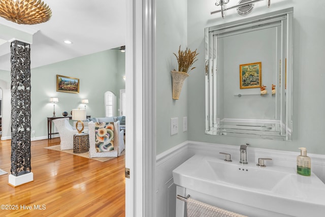 bathroom with recessed lighting, a sink, and wood finished floors