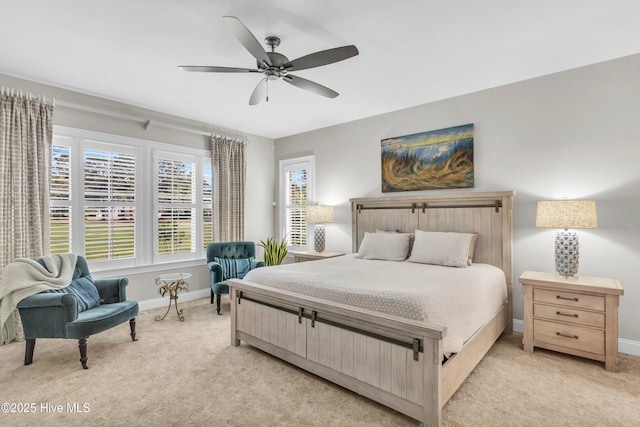 bedroom featuring a ceiling fan, baseboards, and light colored carpet