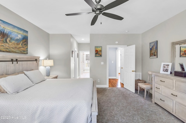 bedroom featuring light carpet, baseboards, and a ceiling fan