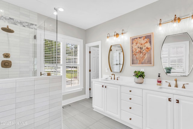 full bathroom with a sink, tile patterned flooring, walk in shower, and double vanity