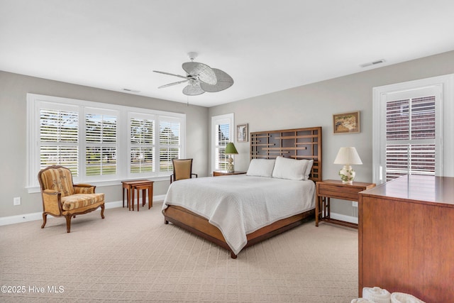 bedroom with ceiling fan, baseboards, visible vents, and multiple windows