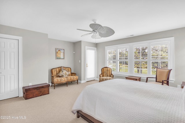 carpeted bedroom featuring baseboards, ceiling fan, and visible vents