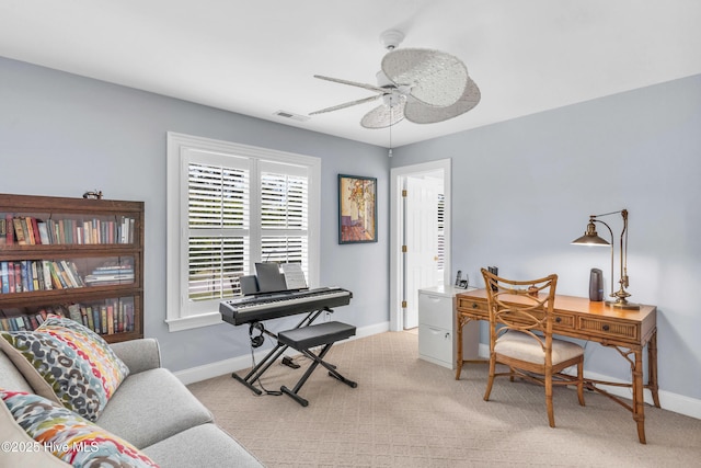 home office with baseboards, ceiling fan, light carpet, and visible vents