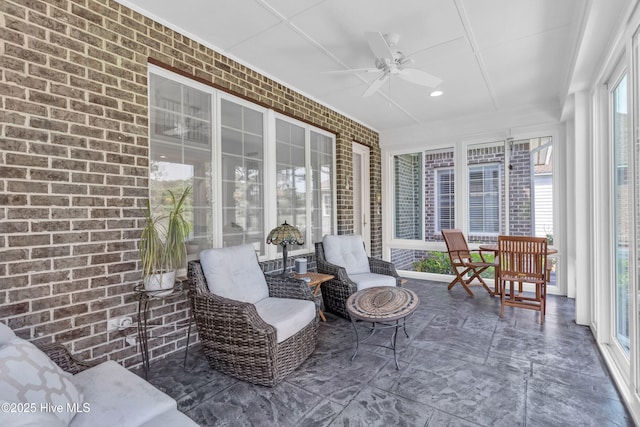 sunroom / solarium featuring a ceiling fan