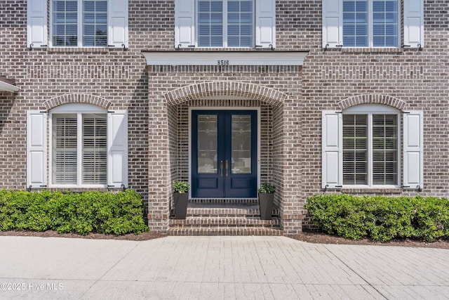 property entrance with french doors and brick siding