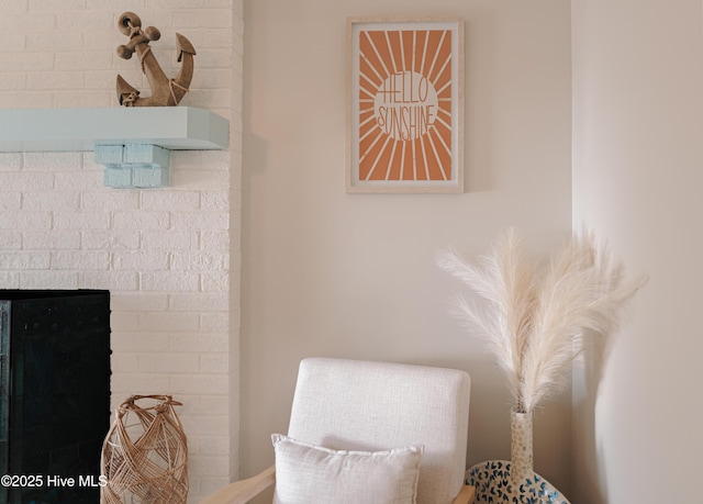 living area with a brick fireplace