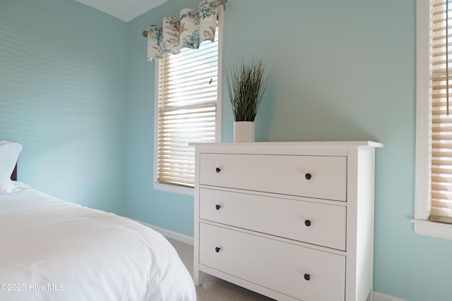 bedroom with baseboards and carpet flooring