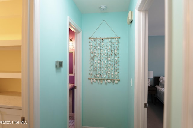 hallway featuring baseboards