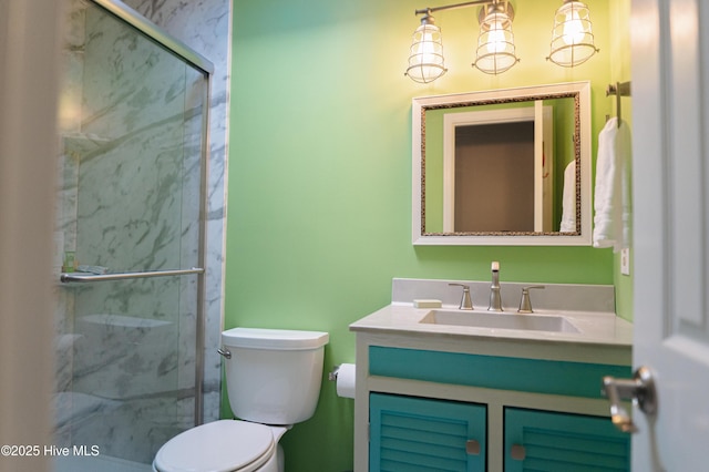 bathroom featuring a marble finish shower, vanity, and toilet