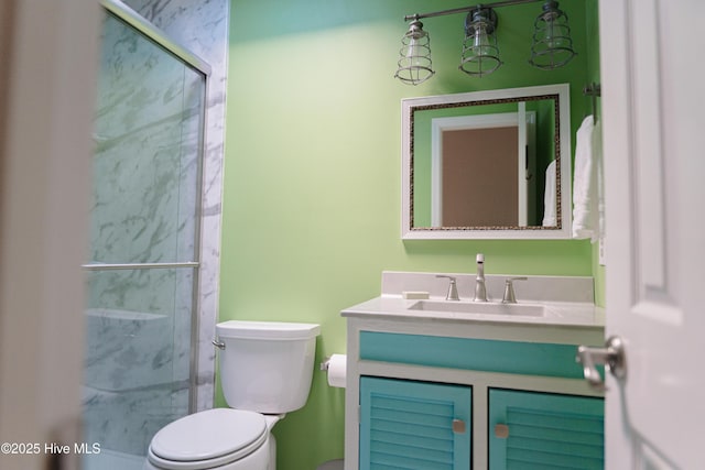 bathroom featuring vanity, toilet, and a marble finish shower