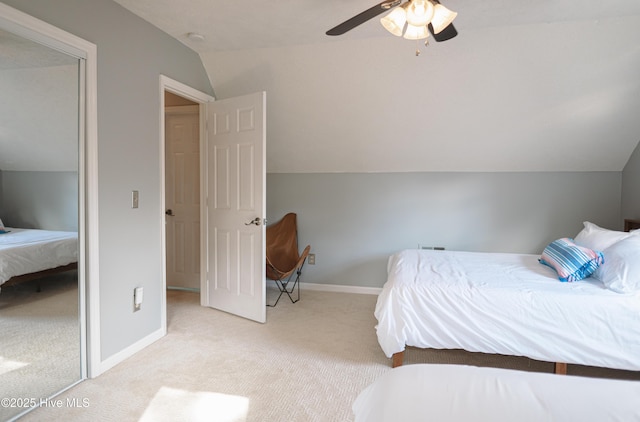 bedroom with light colored carpet, lofted ceiling, ceiling fan, and baseboards