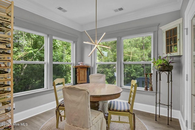 489 Broomsedge Ct SE, Bolivia, NC 28422 - dining area featuring baseboards, crown molding, and wood finished floors
