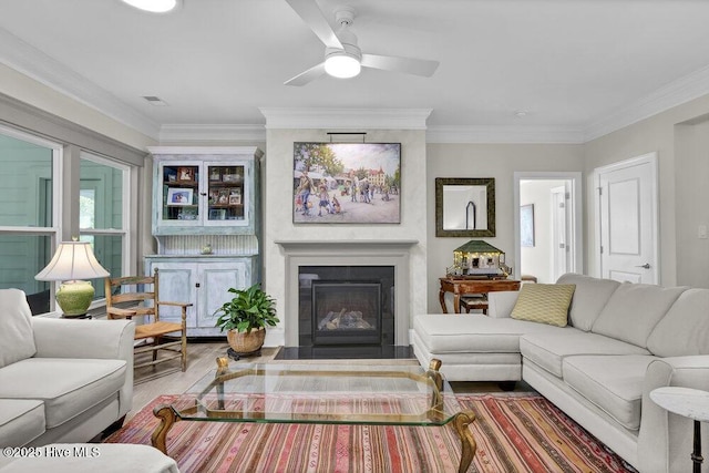 489 Broomsedge Ct SE, Bolivia, NC 28422 - living area with wood finished floors, a glass covered fireplace, crown molding, and ceiling fan
