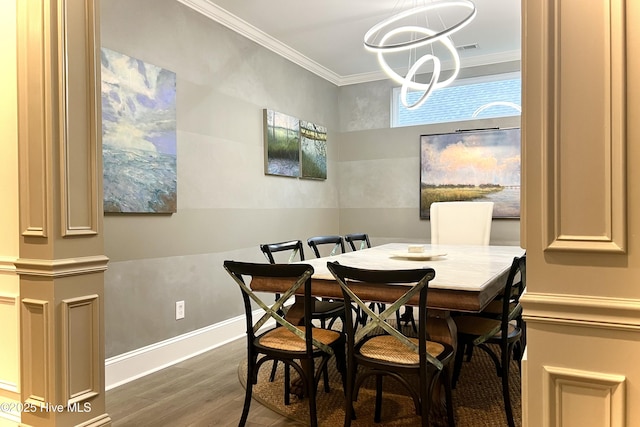 489 Broomsedge Ct SE, Bolivia, NC 28422 - dining space featuring wood finished floors, ornamental molding, a chandelier, and baseboards