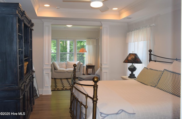 489 Broomsedge Ct SE, Bolivia, NC 28422 - bedroom with decorative columns, dark wood finished floors, crown molding, a raised ceiling, and recessed lighting