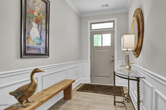 489 Broomsedge Ct SE, Bolivia, NC 28422 - foyer with crown molding, a wainscoted wall, wood finished floors, and a decorative wall