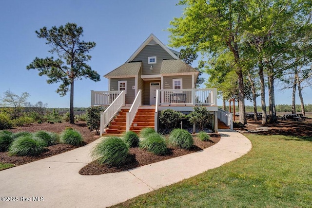 489 Broomsedge Ct SE, Bolivia, NC 28422 - view of front of house featuring stairs, a wooden deck, and a front yard