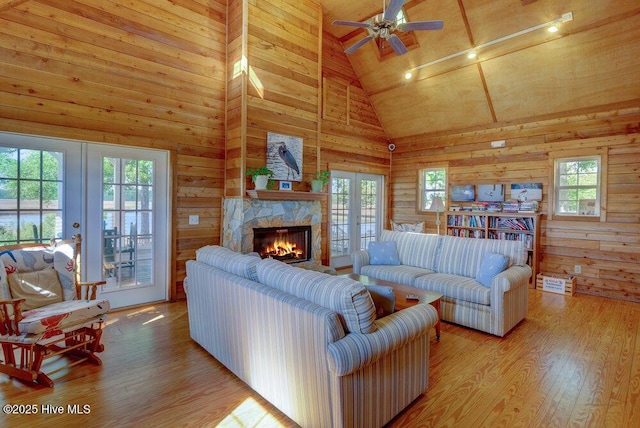 489 Broomsedge Ct SE, Bolivia, NC 28422 - living area with french doors, wooden ceiling, wood finished floors, high vaulted ceiling, and a fireplace