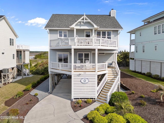 126 S Permuda Wynd Dr, North Topsail Beach, NC 28460 - beach home with a carport, a balcony, a shingled roof, and stairway
