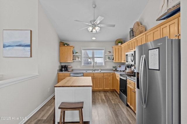 126 S Permuda Wynd Dr, North Topsail Beach, NC 28460 - kitchen featuring appliances with stainless steel finishes, open shelves, light brown cabinetry, light wood-style floors, and ceiling fan