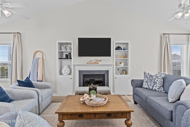 126 S Permuda Wynd Dr, North Topsail Beach, NC 28460 - living room featuring a ceiling fan, lofted ceiling, a glass covered fireplace, and built in features