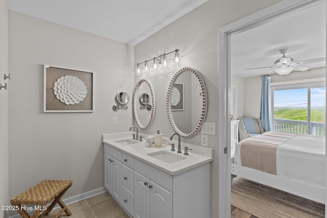 126 S Permuda Wynd Dr, North Topsail Beach, NC 28460 - full bath with double vanity, tile patterned floors, baseboards, and a ceiling fan