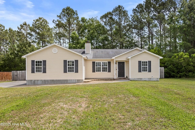 single story home featuring fence, a front yard, and a chimney