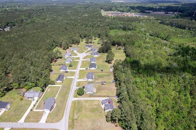 birds eye view of property with a view of trees