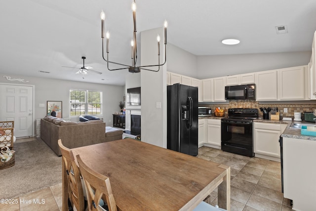 kitchen with decorative backsplash, ceiling fan, white cabinets, black appliances, and open floor plan