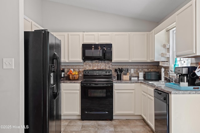 kitchen featuring vaulted ceiling, tasteful backsplash, black appliances, and a sink
