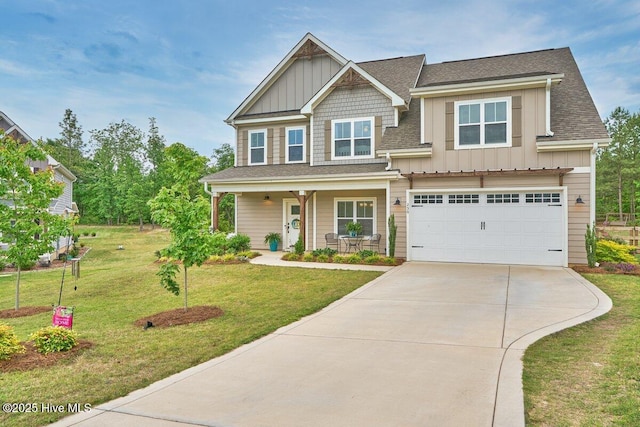 craftsman inspired home featuring board and batten siding, driveway, a porch, and a front yard