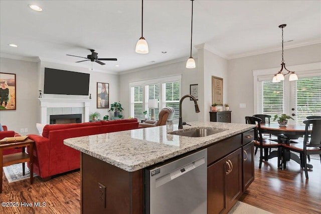 kitchen with a sink, stainless steel dishwasher, dark wood-type flooring, ceiling fan, and open floor plan