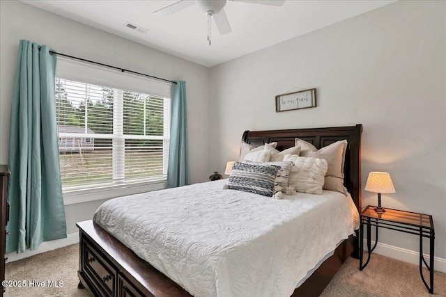 bedroom with light colored carpet, baseboards, and ceiling fan